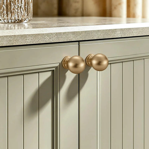 Premium Zinc Alloy Cabinet Knobs And Drawer Pulls One Inch Round Ball Champagne Bronze Finish on a kitchen cabinet door.