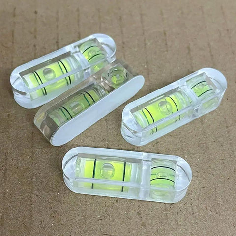 Tiny But Mighty 3 Pack Mini Bubble Spirit Levels Hella Compact Acrylic Measuring Tools on a flat surface.