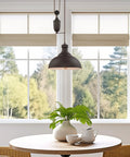 Sequoia 13 Inch Dope Industrial Pulley Pendant Light With Dome Shade And Counterweight In Oil Rubbed Bronze over round table.