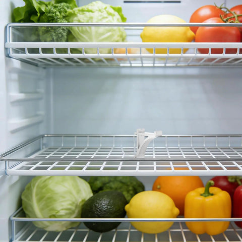 Refrigerator Shelf Clips Set of 8 Sturdy Aluminum Fridge Shelf Supports, silver clip securing shelf with vegetables in view.