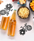 Stainless Steel Bike Multitool Keychain with bicycle-shaped design next to snacks and drinks, portable cycling tool for maintenance.
