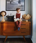 Child sitting on vintage cabinet with 45 Pack Matte Black Stainless Steel Cabinet Pulls 7.38 Inch Length With 5 Inch Hole Center Dope Modern Kitchen Drawer Cupboard Handles For Cabinets Easy Install And Lasting Finish in a cozy room.