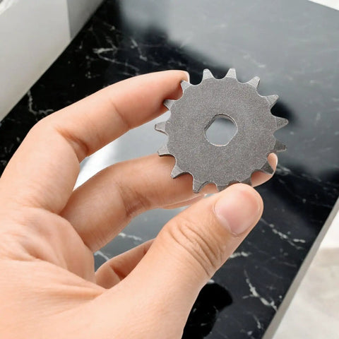 Hand holding 15 Tooth T8F Sprocket For 10mm Shaft Electric Scooters And Mini Bikes, heavy-duty metal chain wheel, 15T gear.