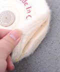 Close-up of 6 inch white cloth polishing buffing wheel for jewelry and stainless steel, showing texture and fabric layers.