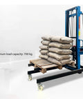 Heavy Duty Steel Hoist Portable Mobile Elevator With Casters Raises Twenty Feet Handles Duct Bricks Plumbing Gear Bulletproof For Busy Job Sites Takes The Heavy Lifting Easy On Your Crew with 700kg capacity and loaded with bags on a pallet.