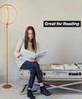 Woman reading next to Eclipse Dope Bright Modern LED Torchiere Floor Lamp With Built In Touch Dimmer, gold finish.