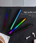 Top view of RGB Rechargeable Sound Control Lights With Voice Activated Music Rhythm set next to laptop on dark surface