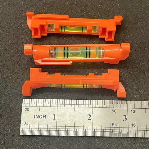 5 Piece String Line Bubble Level Set With Hanging Acrylic Vials Built For Kickass Layout Work And Precision Site Marking Rock Solid Measuring Tool That Gets The Job Done Right Every Time, showing three orange vials with measuring tape.