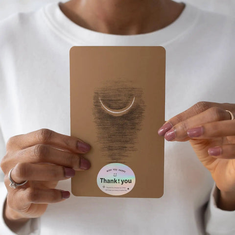 Person holding Thank You Stickers for Packaging and Gift Wrapping on copper plate with self adhesive sealing labels shown.