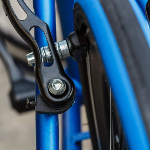 Close-up of V Bike Brake Pads With Hex Nuts And Spacers Set 70 Mm Black Designed For Durable V Brakes on a blue bike frame.