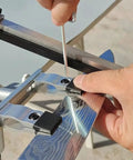 Hardcore Knife Sharpening Kit Featuring Eleven Premium Whetstones And Diamond Stones For Cutting Edge Blades includes an adjustable metal clamp in use.