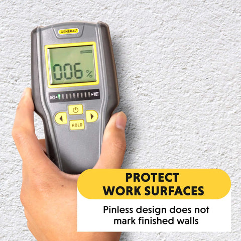 Digital Moisture Meter With Pinless Humidity Sensor MMD7NP held against a white wall showing a reading on the display.