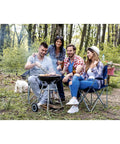 Group of people enjoying outdoor cookout with Stainless Steel BBQ Grill Tools Set With Ergonomic Wood Handles Includes Spatula Tongs Knife Fork And Carry Bag For Outdoor Grilling And A Great Gift For Men Dad Who Love Backyard Barbecues And Weekend Cookouts