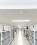 Ceiling Mount 360 Degree PIR Occupancy Sensor installed in a school hallway ceiling, automating lighting at 15 ft high, 120-277V.