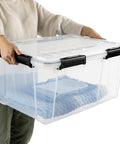 Rock Solid Clear Stackable Plastic Storage Bins With Resilient Gasket Seals Keep Your Stuff Protected While Stacking Tall In Garage These 80 Quart Bins Are A Total Game Changer For Bulk Organization Including This Sweet Value 8 Pack Set, shown being held with blankets inside.