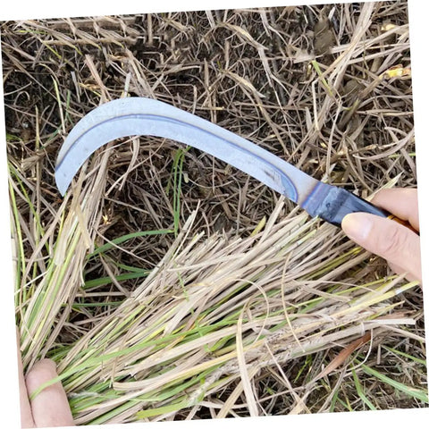 Lightweight Garden Mower And Reaping Tool being used on dry grass with durable solid wood handle ideal for outdoor work