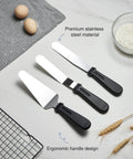 Three stainless steel icing spatulas with ergonomic handles on a kitchen counter