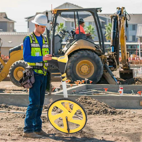 Aramox Digital Measuring Wheel with Backlit LCD 5-Button Control Memory Storage 99999ft Range in use at a construction site.