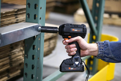 Person using Brushless Cordless Impact Wrench With 20V Max Power 2.0Ah Li Ion Battery And Charger Delivers Up To 3400 Impacts And 2300 RPM Beastly Compact 6.5 Inch Design For Tight Bolts And Lug Nuts on metal shelving