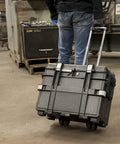 Gray Heavy Duty Rolling Tool Chest With Four Deep Locking Drawers, Stackable Industrial Workhorse, Impact Resistant And Water Proof Build For Pros On The Move being rolled in a workshop.