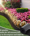 Installed garden edging using 2 Pack Felt Mulch Roll For Landscaping 120 Inch By 5.9 Inch Cuttable Garden Edging Border With 20 U Shaped Stakes Weed Barrier Mat Keeps Weeds At Bay And Durable PE Backing For Flower Beds Lawns And Pathways, shown with vibrant flower bed.
