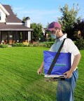 Person using 25Lb Seed Spreader With Waterproof Bag And Precise Gears For Accurate Lawn Seeding, handheld grass spreader, blue color