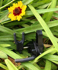 Drop Away Arrow Rest for Compound Bow, Aluminum Alloy CNC Machined, Right Hand, in grassy setting with yellow flower