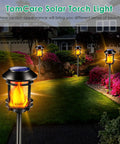 Outdoor Solar Torch Lights With Flickering Flame illuminating a garden pathway, showcasing realistic flame effect for ambience.