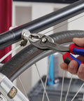 8 Inch Comfort Grip Pliers With Front And Side Gripping used on a bike cable for versatile lock in adjustments
