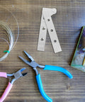 Stainless Steel Hidden Door Hinges 4 Pack with thickened design on wooden table with crafting tools and materials.