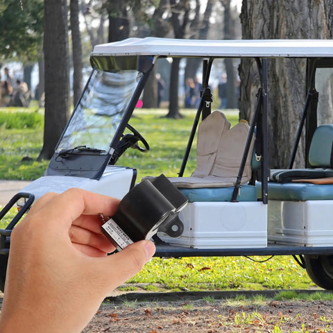 Hand holding Inductive Throttle Sensor Upgrade for Golf Carts with Hall Effect Technology, golf cart in background