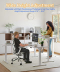 Spacious YIHAYO L Shaped Standing Desk Adjustable Height Electric Corner Computer Desk With Splice Board For Home Office White in use with height adjustments.