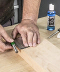 No Sweat Diamond Tool Sharpening Kit With Double Sided Credit Card Stone in use on wooden workbench with lapping fluid.