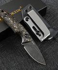 DC53 Steel Fixed Blade Knife With Rugged Shredded Carbon Fiber Handle And Kydex Sheath on black surface