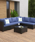 7 Piece Outdoor Patio Sectional Wicker Rattan Set In Coffee Blue With Waterproof Cushions on wooden deck with plants