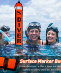 3 scuba divers smiling near 5Ft Surface Marker Buoy Set With Open Bottom DSMB, High Visibility Orange SMB in water
