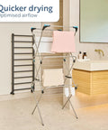 Rock Solid Three Tier Clothes Drying Rack With Foldable Setup For Indoors Or Outdoors Heavy Duty Steel Frame packs nearly seventy feet of drying space with shirts hung up.