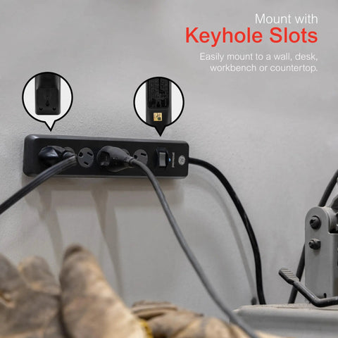 Heavy Duty Six Outlet Surge Protector Power Strip With Four Foot Extension Cord And 800 Joules Protection mounted on a wall with keyhole slots.