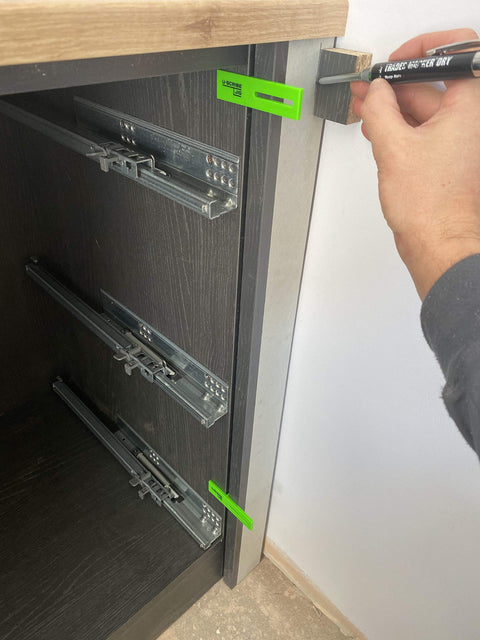 Hand using Pro Grade Scribe Jig Installers Set For Woodworking And Carpentry Makes Cabinet Fillers Toe Kicks And Ceiling Scribes A Breeze