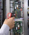 Hand using No Touch Infrared Thermometer With Ten To One Spot Ratio For Fast, Accurate Temperature Readings From A Distance on circuit board