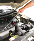Using telescoping magnetic grabber tool to retrieve metal object from car engine bay
