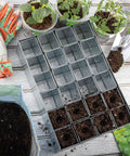 Galvanized Metal Seed Starter Tray With 24 Removable Pots, Germination Kit For Sprouting And Indoor Seed Starting on wooden table.