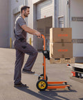 Worker using hydraulic material lift winch stacker with 450 lb capacity and 35.4 inch lift height in warehouse loading area