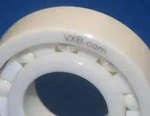 Close-up of 6312 Full Ceramic Bearing ZrO2/PTFE C3 FIT 60mm x 130mm x 31mm, showing ceramic ball bearing with PTFE cage